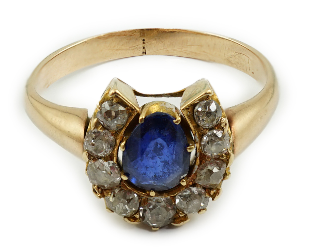 An early to mid 20th century gold, sapphire and diamond set horseshoe cluster ring